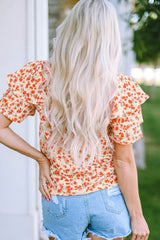 Blusa con mangas abullonadas y estampado floral naranja