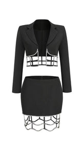 MINIVESTIDO DE LICRA CON ABERTURAS Y PIEDRA FRESA EN NEGRO