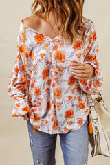 Orangefarbene Dolman-Bluse mit V-Ausschnitt und Blumenmuster