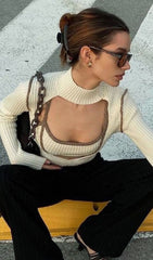 High-necked long-sleeved suspender top.