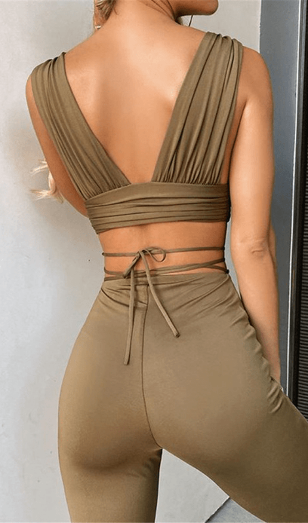 Open-back top and high-waisted bootcut trousers.